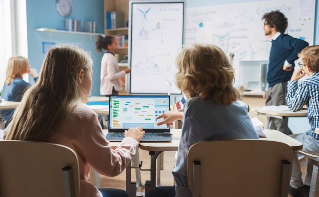 Students in a classroom using blended language learning technology