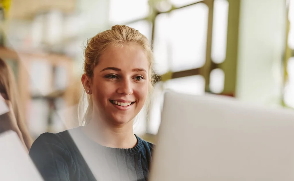 A Photo of a female student studying languages using a laptop