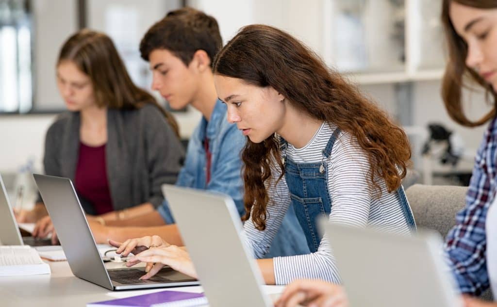 Students working on an exam using their laptops