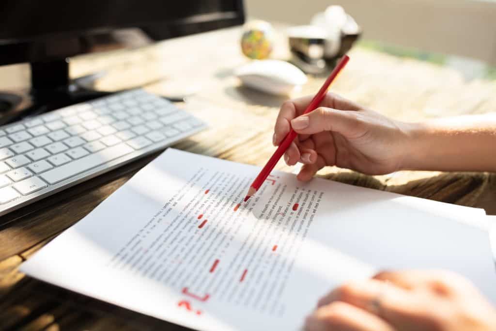 Deductive grammar and language teaching - illustration image of a teacher correcting a student's assignment