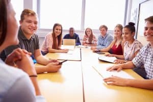 Students engaged in a round table discussion during a class